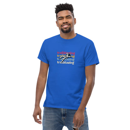 Smiling man in a royal blue classic tee with vibrant 'trailblazing' text, embodying the spirit of boldness and individual trailblazing attitude.