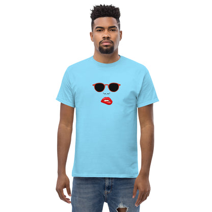 Man wearing a blue classic tee with a quirky red lips and sunglasses graphic, channeling a fun and bold personal style statement.