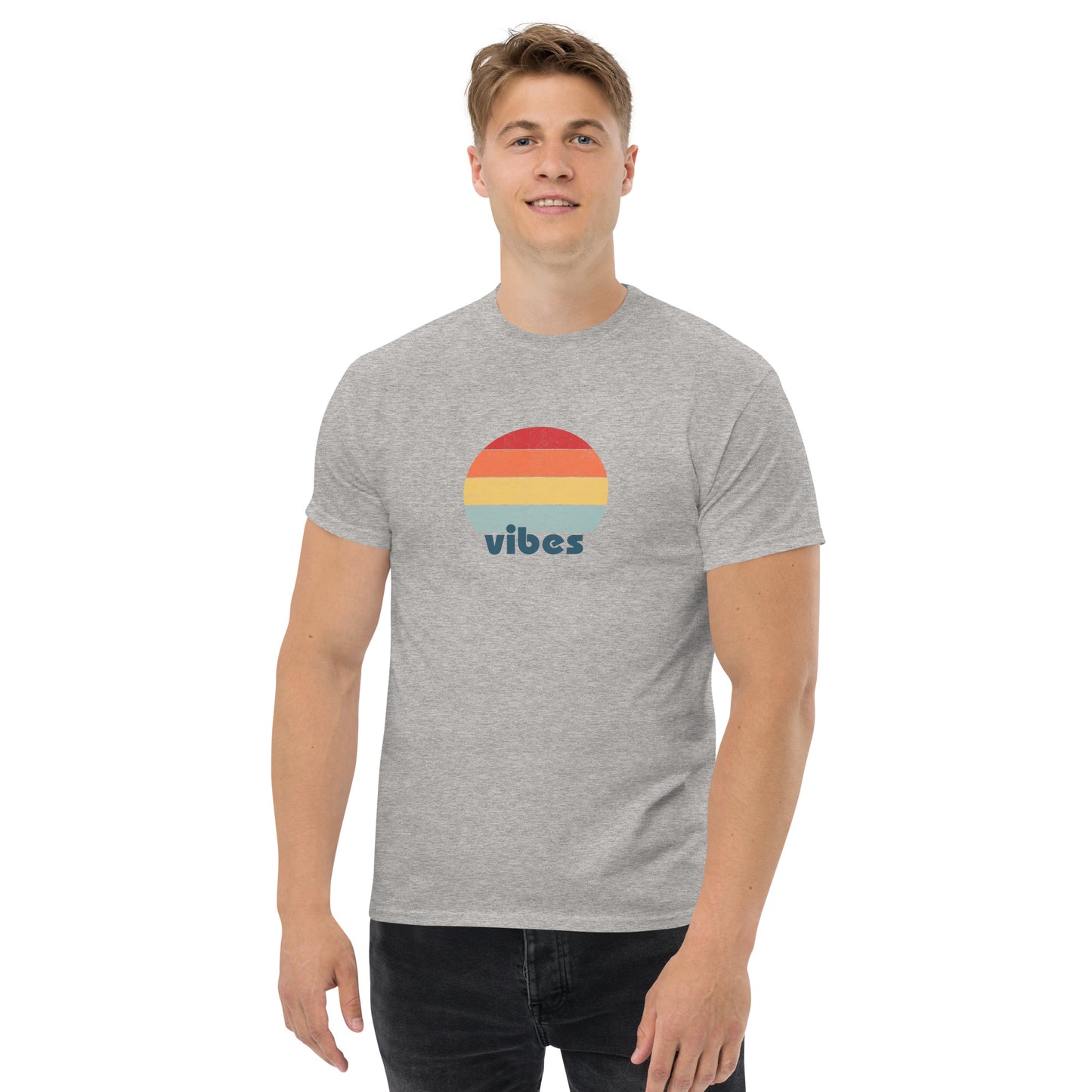 Confident man sporting a grey classic tee with a colorful retro sunset design and 'vibes' text, evoking a relaxed and inspiring mood.