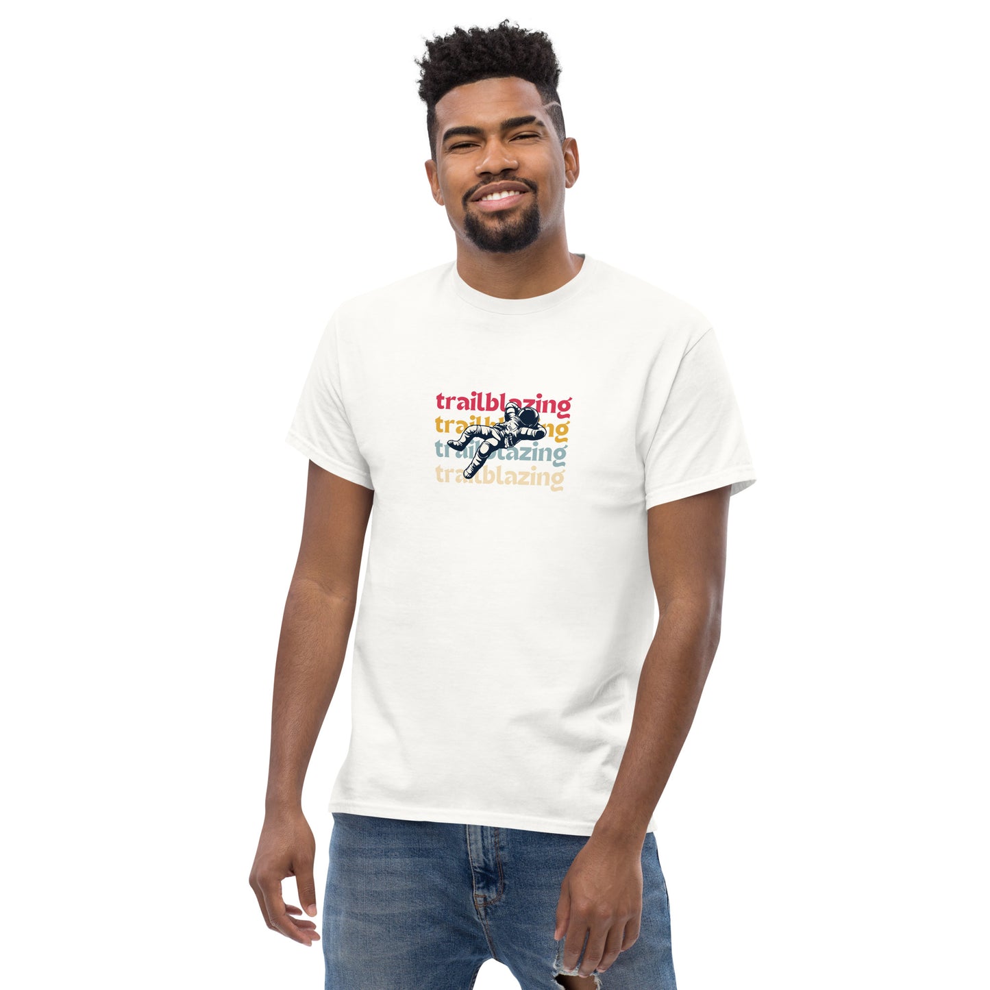 Smiling man in a white classic tee with vibrant 'trailblazing' text, embodying the spirit of boldness and individual trailblazing attitude.