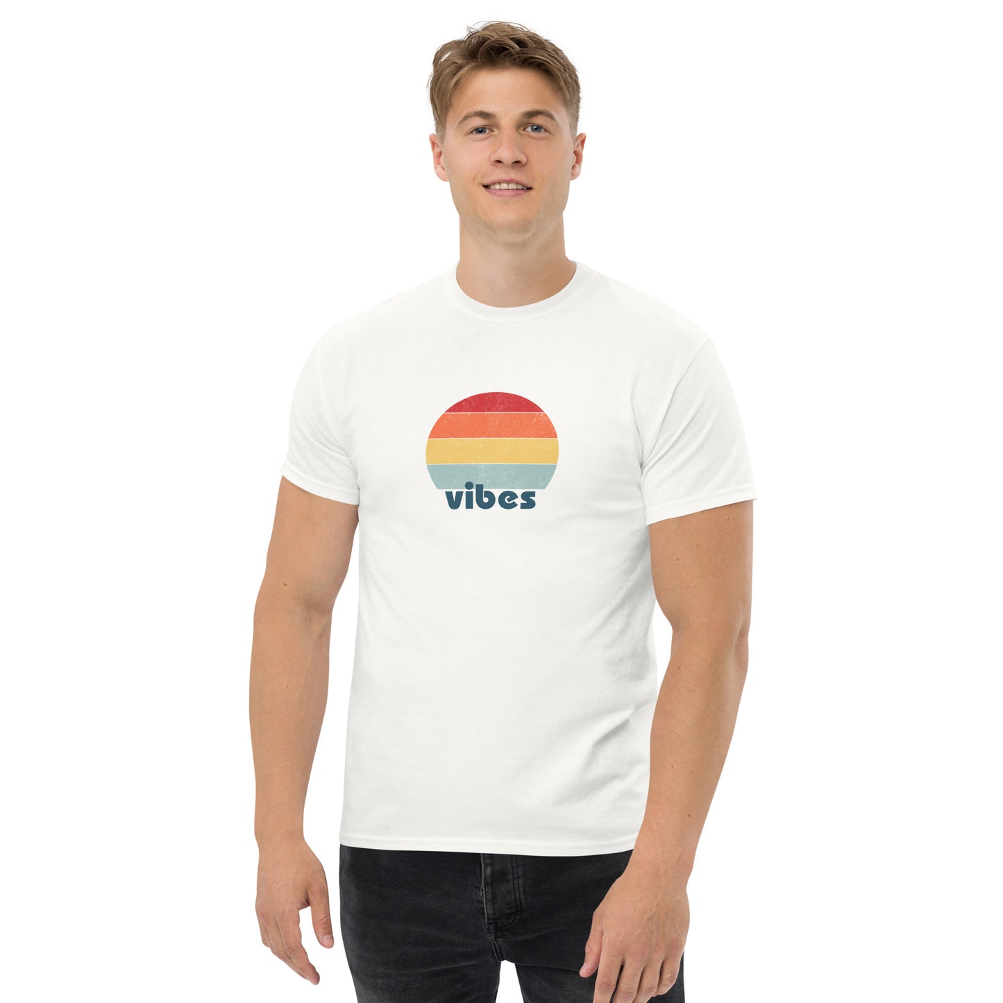 Confident man sporting a white classic tee with a colorful retro sunset design and 'vibes' text, evoking a relaxed and inspiring mood.