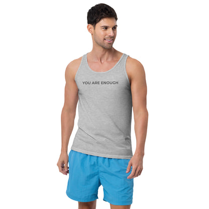 Man wearing a athletic grey sleeveless tank with "You Are Enough" text. 