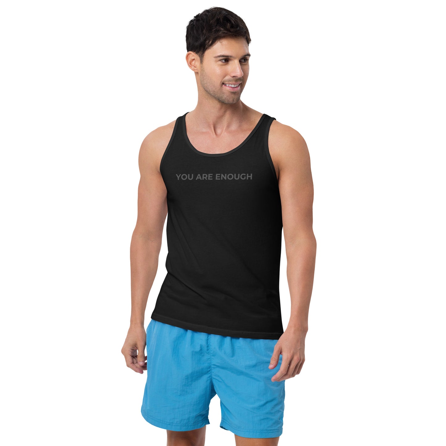 Man wearing a black sleeveless tank with "You Are Enough" text. 