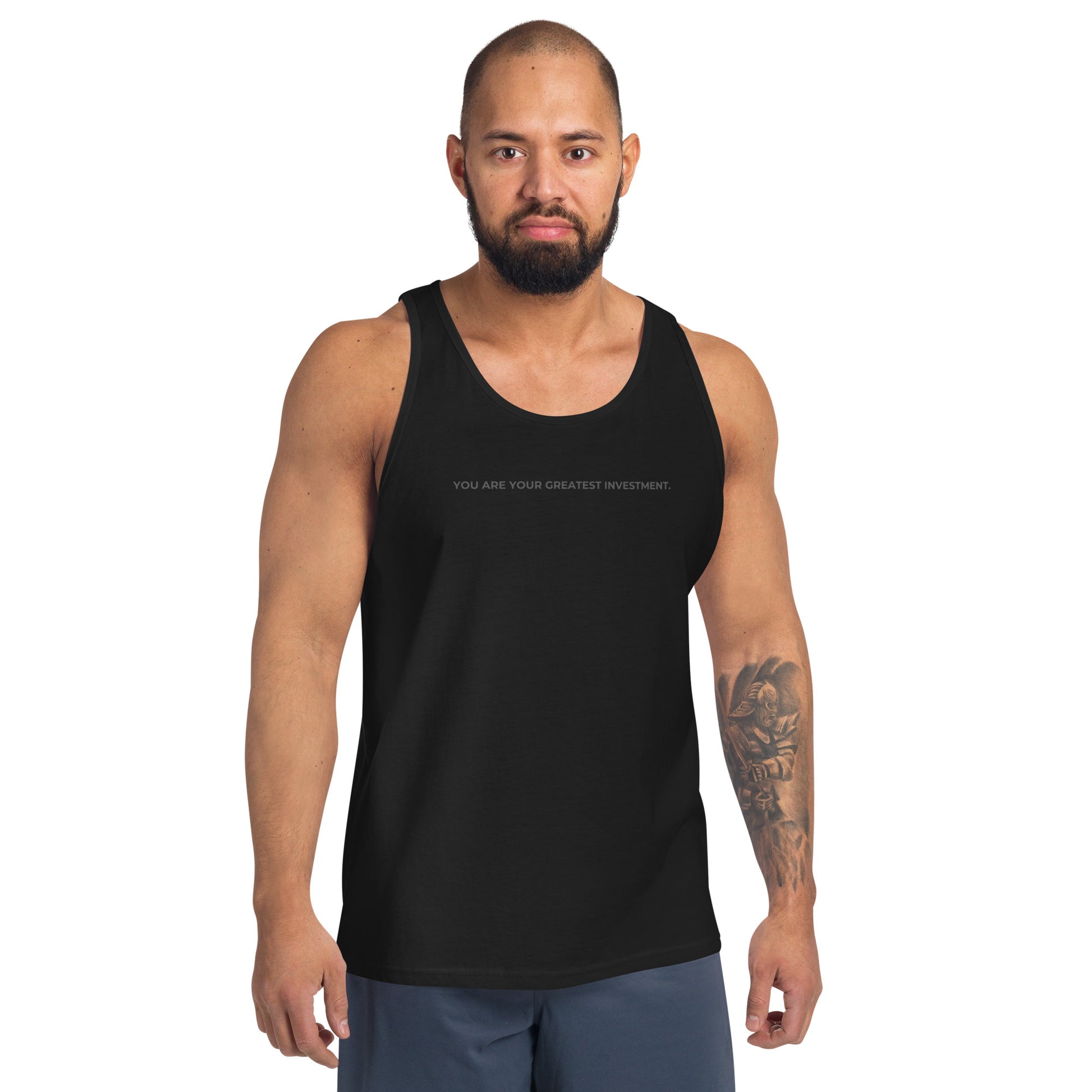 Man wearing a black sleeveless tank with "You Are Your Greatest Investment" text. 