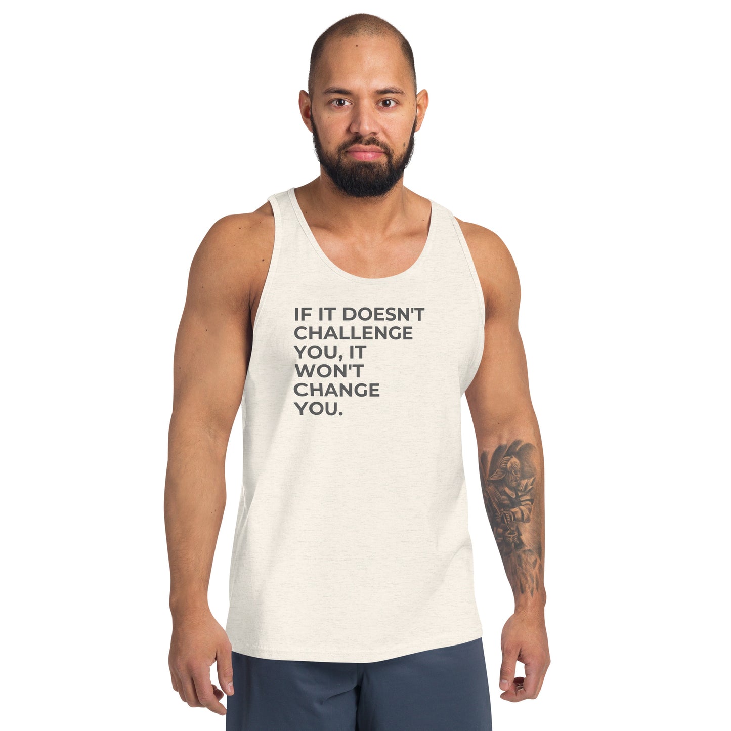 Man wearing an oatmeal triblend sleeveless tank with "If It Doesn’t Challenge You, It Won’t Change You" text. 