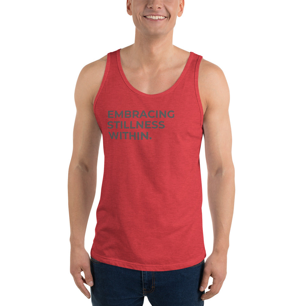 Man wearing a triblend red sleeveless tank with "Embracing Stillness Within" text. 