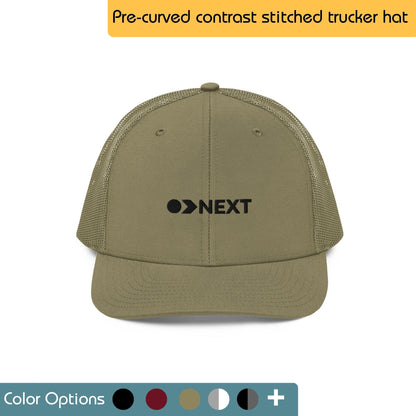 Black trucker hat with the word "NEXT" embroidered in white on the front. Text "Trucker Hat" is written above the image, and "Color Options+" is written below the image.