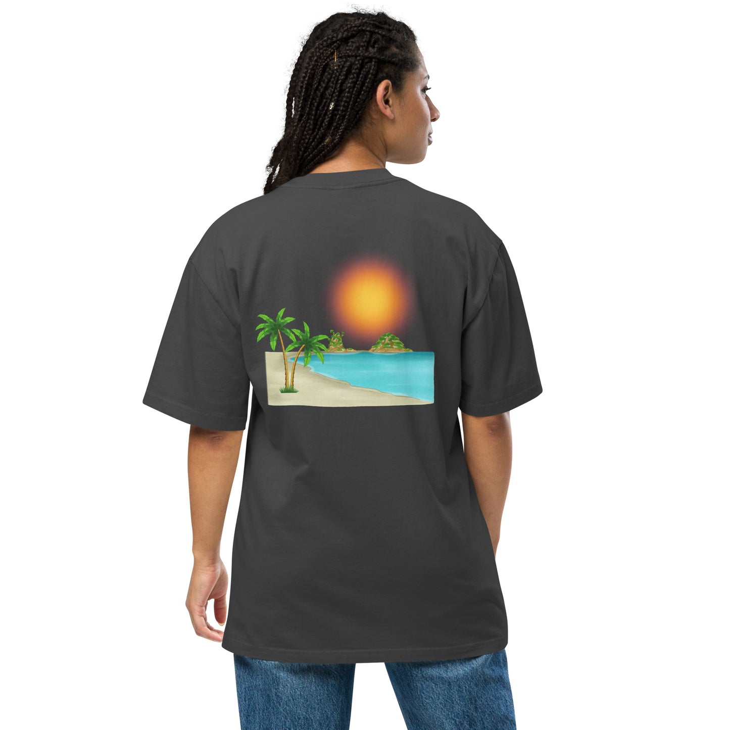 Woman in a faded black oversized T-shirt with a vibrant beach sunset graphic.