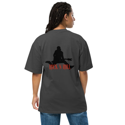 Woman facing away, wearing a Be You Out Loud faded black oversized tee with a "Rock N Roll" silhouette design, exuding a vintage yet edgy style