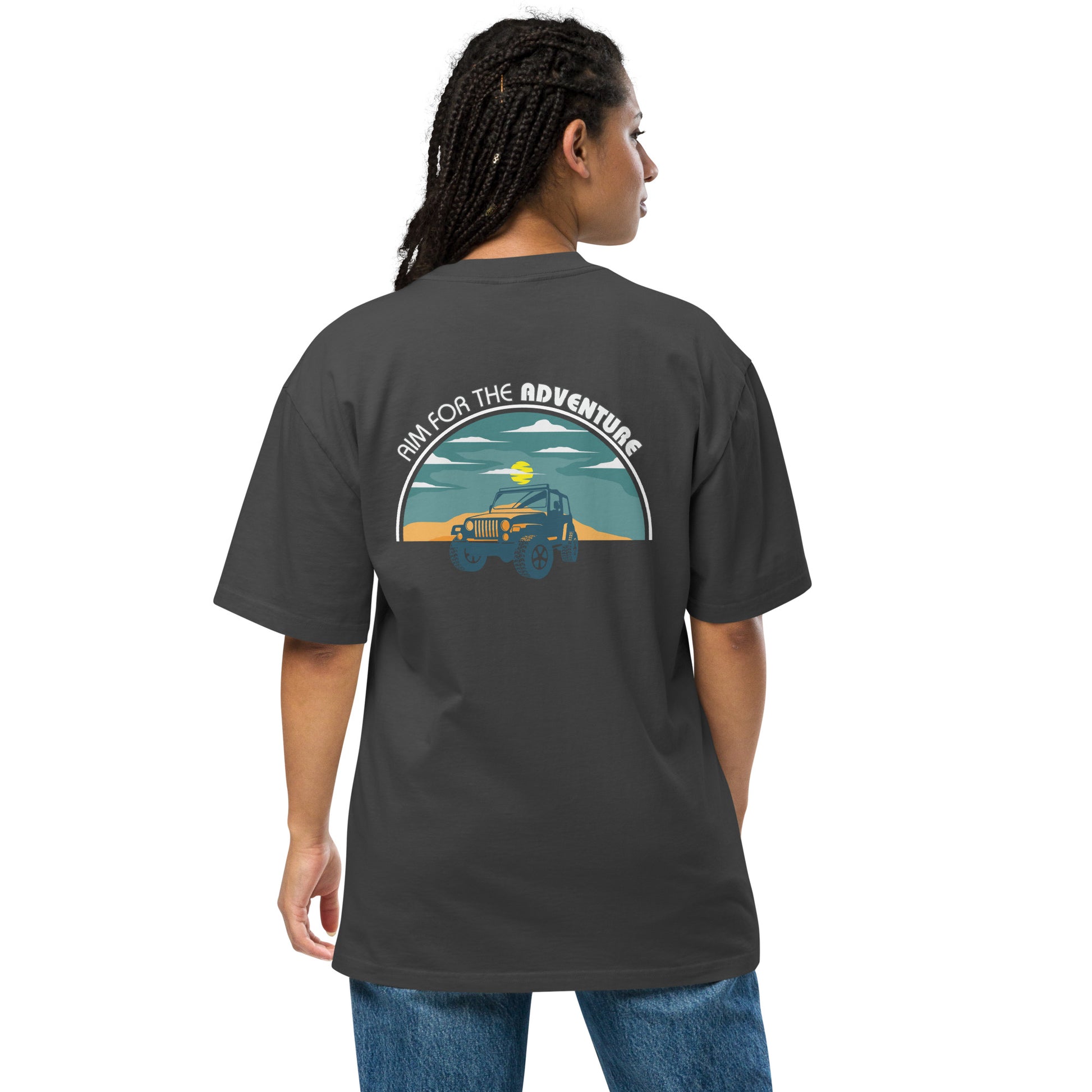 Woman showcasing Women's Quirky Adventure faded black Oversized Graphic Tee with retro jeep design, ideal for those who love a dash of whimsy on their adventures.