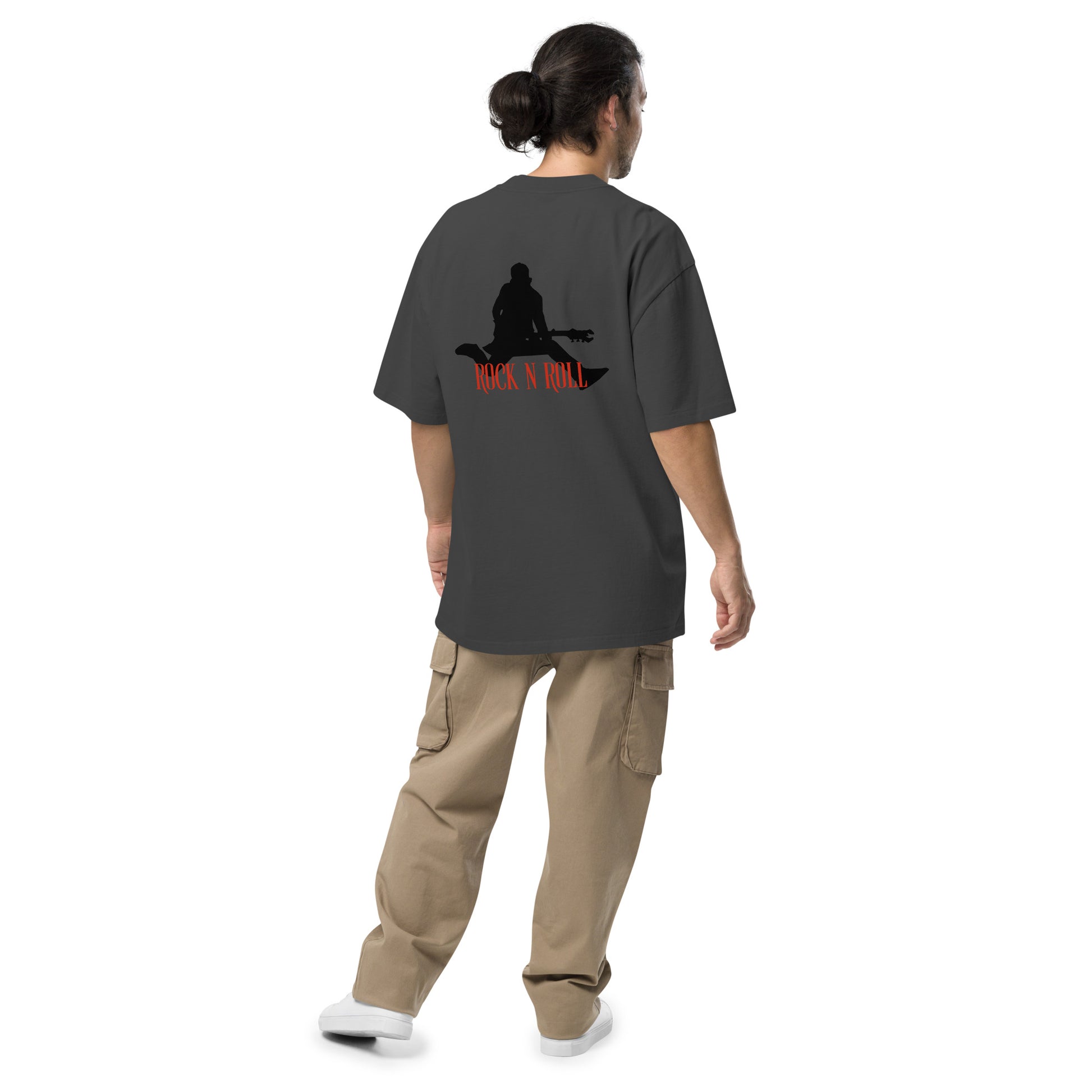 Rear view of a man wearing  Men’s Iconic Rock n’ Roll faded black Oversized Tee, exuding a timeless, rebellious spirit.