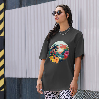 Fashion-forward woman in a Women's Tropical Sunset faded black Oversized Tee featuring a vibrant, artistic print of palm trees and flowers, paired with statement leopard print pants and chic sunglasses, encapsulating a fresh, summery aesthetic.