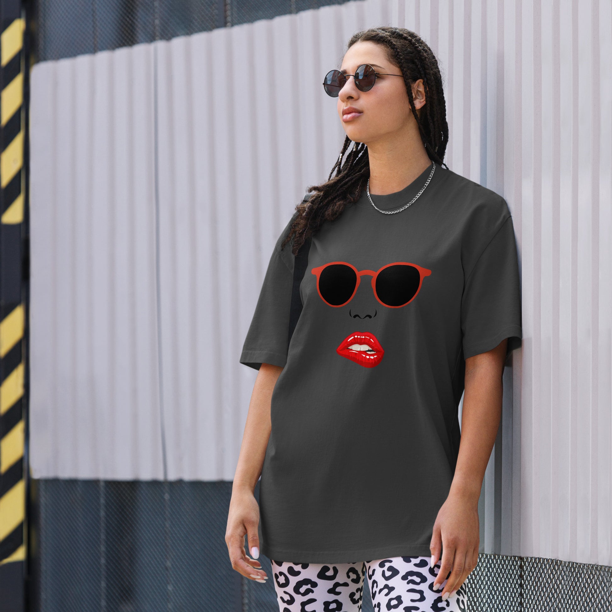 Woman wearing a Women's Quirky Retro Red Specs faded black Oversized Graphic Tee, embodying cool self-expression with a touch of retro charm.