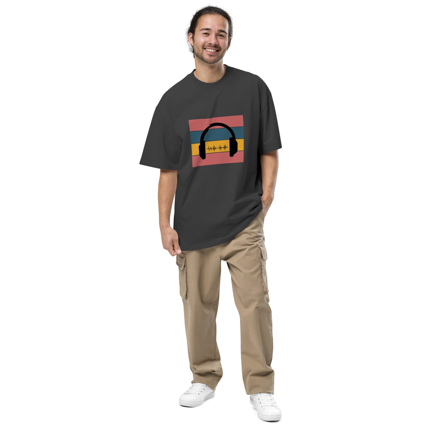 Man smiling in  Men's "Sound Wave" faded black Oversized Graphic Tee, featuring a colorful headphone and sound wave design, for the music aficionado,