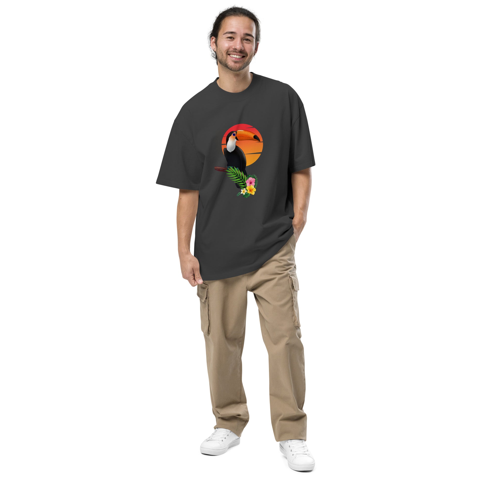 Smiling man in a Men’s Toucan Sunrise Quirky faded black Oversized Tee, highlighting a fun-loving style and unique spirit.