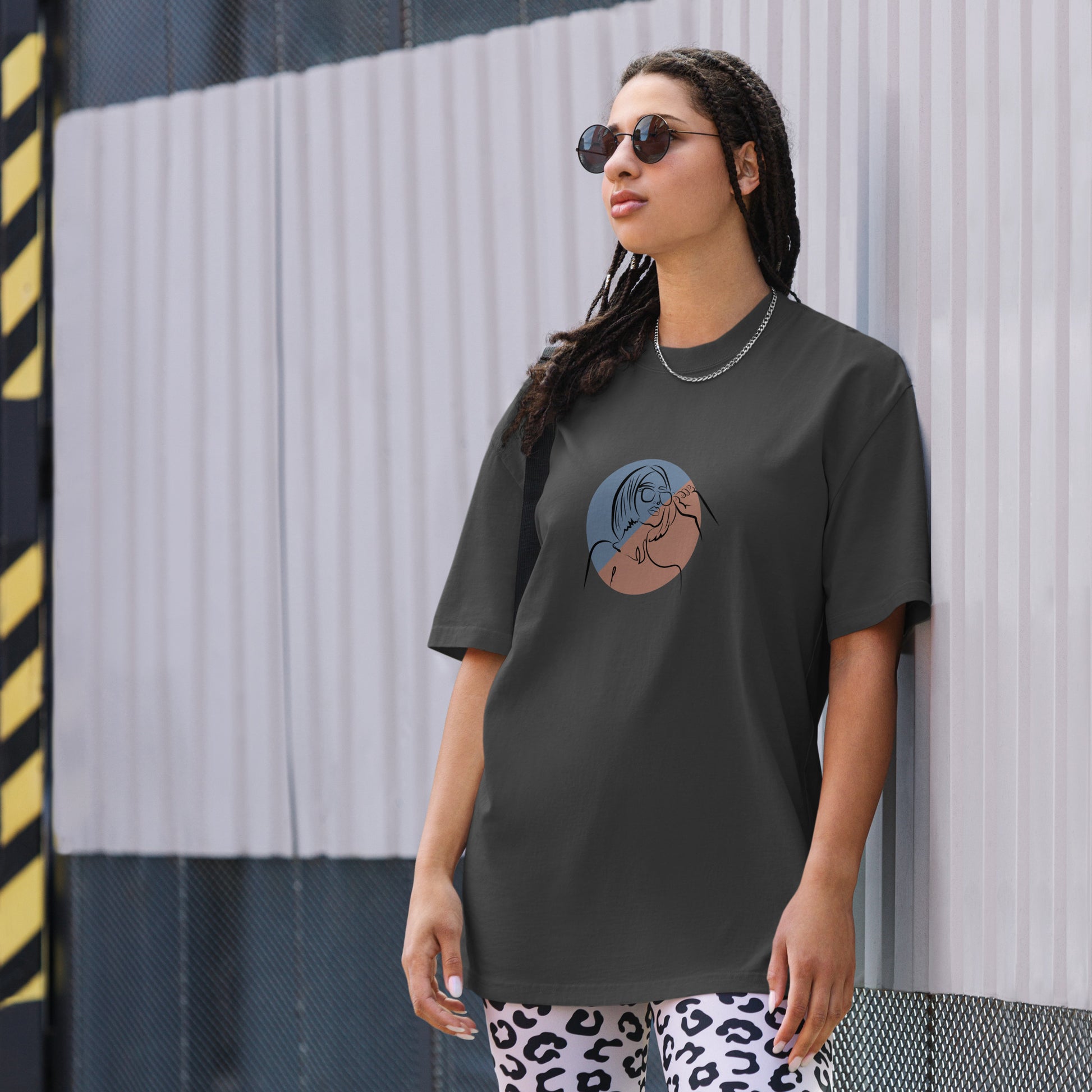 Woman wearing a faded black oversized faded tee with an elegant lady line art design, highlighting unique self-expression and artistic fashion.