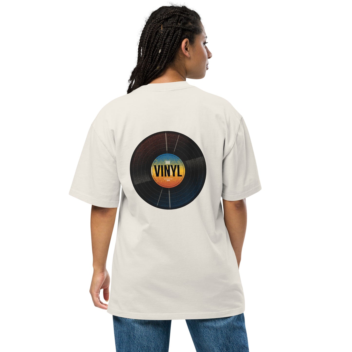 Woman from the back wearing a Be You Out Loud faded bone oversized tee with a colorful vinyl record design, merging classic charm with modern fashion.