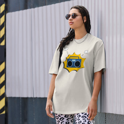 Woman in a faded bone oversized tee with a vibrant yellow retro mixtape graphic, combining classic style with a punch of personality for any casual occasion.