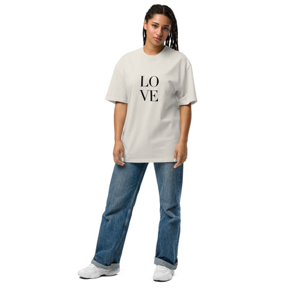 Woman in a faded bone oversized tee with "LOVE" print, showcasing a bold statement style.