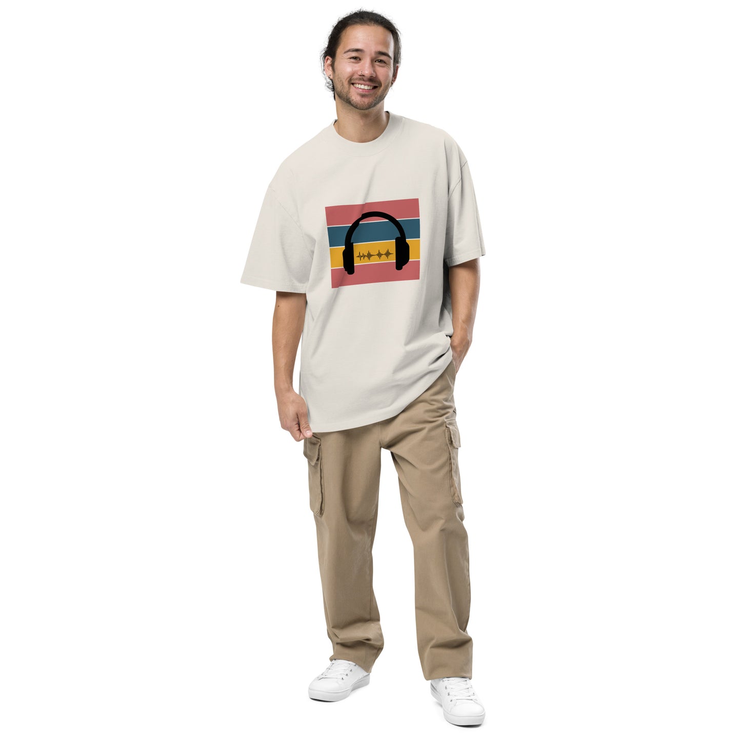 Man smiling in  Men's "Sound Wave" faded bone Oversized Graphic Tee, featuring a colorful headphone and sound wave design, for the music aficionado,