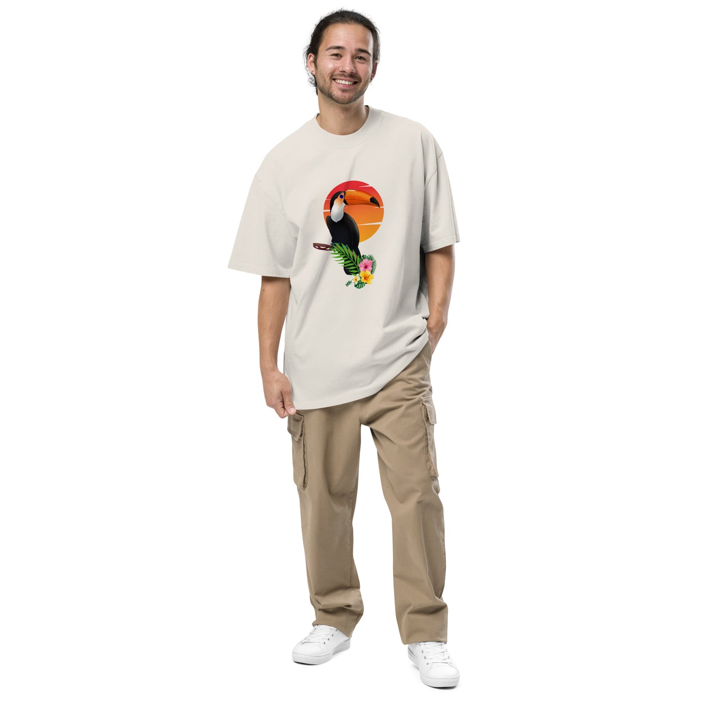 Smiling man in a Men’s Toucan Sunrise Quirky faded bone Oversized Tee, highlighting a fun-loving style and unique spirit.