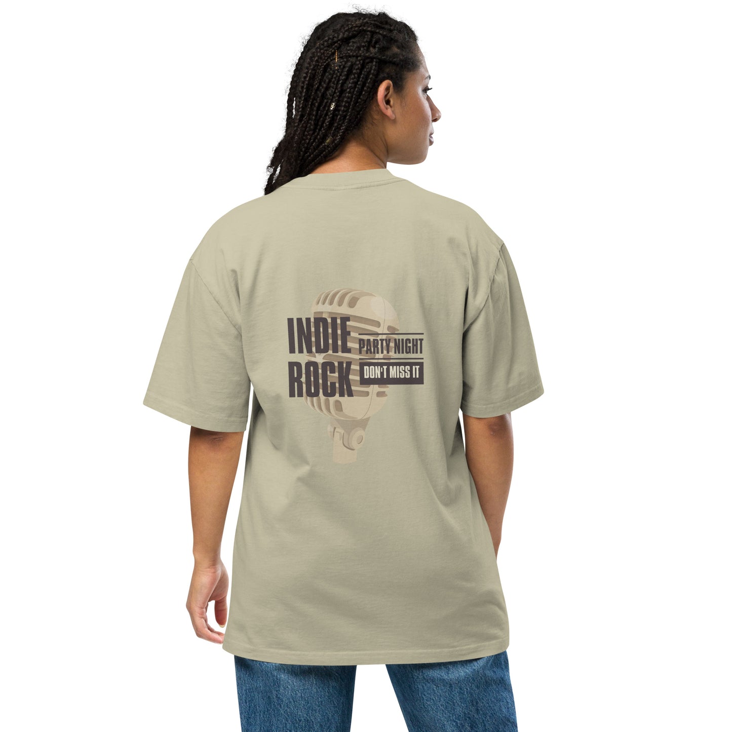 Woman viewed from the back wearing a faded eucalyptus oversized tee with 'INDIE ROCK' text and microphone graphic, promoting 'Party Night – Don’t Miss It', paired with denim jeans, conveying a relaxed music event vibe.