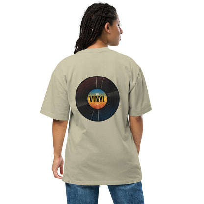 Woman from the back wearing a Be You Out Loud faded eucalyptus oversized tee with a colorful vinyl record design, merging classic charm with modern fashion.