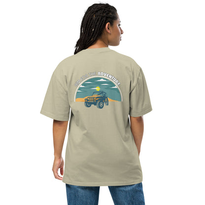 Woman showcasing Women's Quirky Adventure faded eucalyptus Oversized Graphic Tee with retro jeep design, ideal for those who love a dash of whimsy on their adventures.