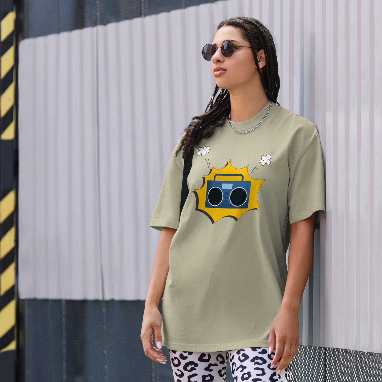 Woman in a faded eucalyptus oversized tee with a vibrant yellow retro mixtape graphic, combining classic style with a punch of personality for any casual occasion.