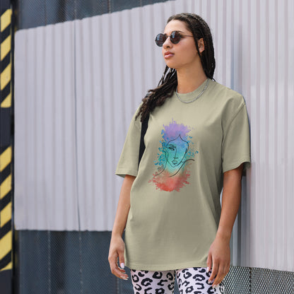 Woman in a faded eucalyptus oversized tee showcasing a vibrant artistic face design, reflecting Be You Out Loud’s celebration of individuality and self-expression.