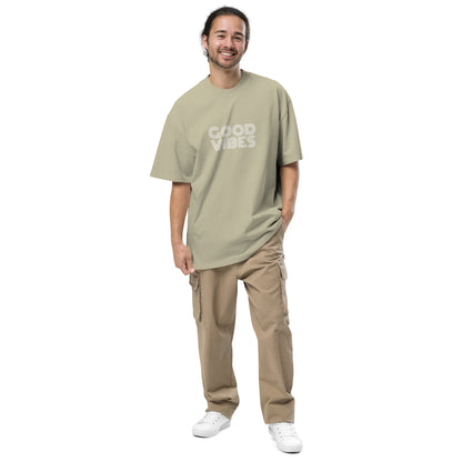 Smiling man in Men's "Good Vibes Only" faded eucalyptus Oversized Tee by Be You Out Loud, embodying positivity and self-expression.