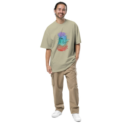 Cheerful man wearing  Men's "Mindful Expression" Artistic faded eucalypyptus' Oversized Graphic Tee, showcasing vibrant abstract face design for a bold statement of individuality.