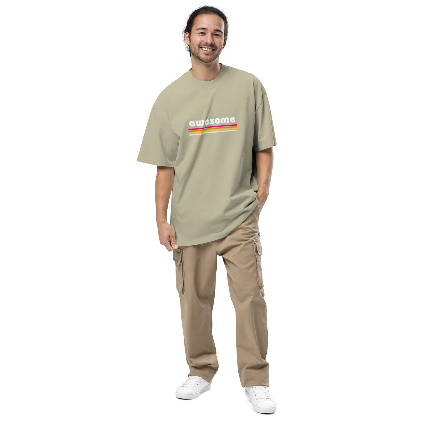 Smiling man sporting the d Men's "Retro Awesome" Oversized Tee in faded aucalyptus with vibrant retro graphics, embodying timeless cool and self-expression.