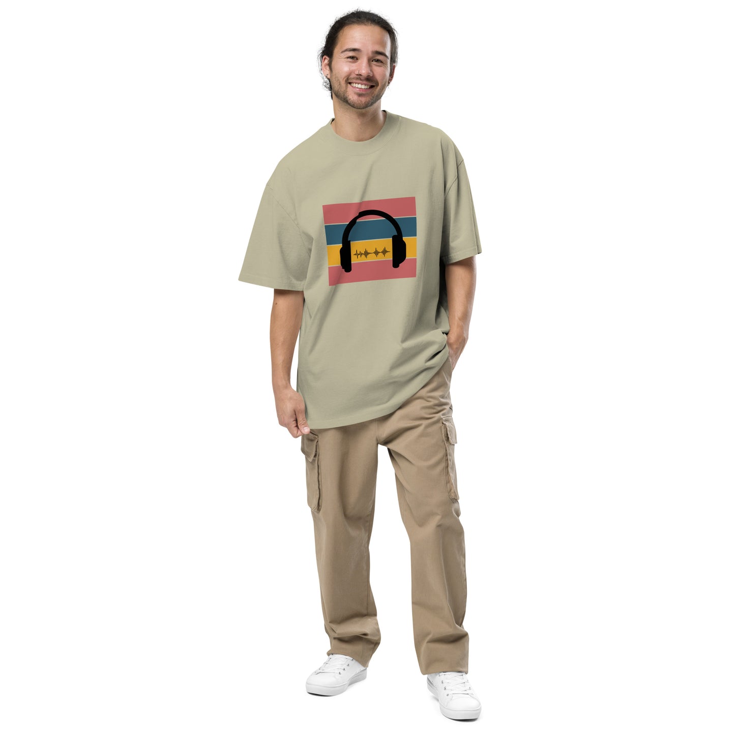 Man smiling in  Men's "Sound Wave" faded eucalyptus Oversized Graphic Tee, featuring a colorful headphone and sound wave design, for the music aficionado,