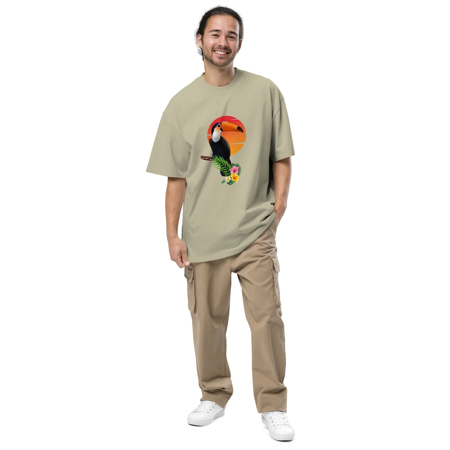 Smiling man in a Men’s Toucan Sunrise Quirky faded eucalyptus Oversized Tee, highlighting a fun-loving style and unique spirit.