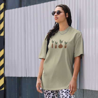 Woman wearing a faded eucalyptus oversized faded tee with a subtle plant design, highlighting unique self-expression and quirky fashion.