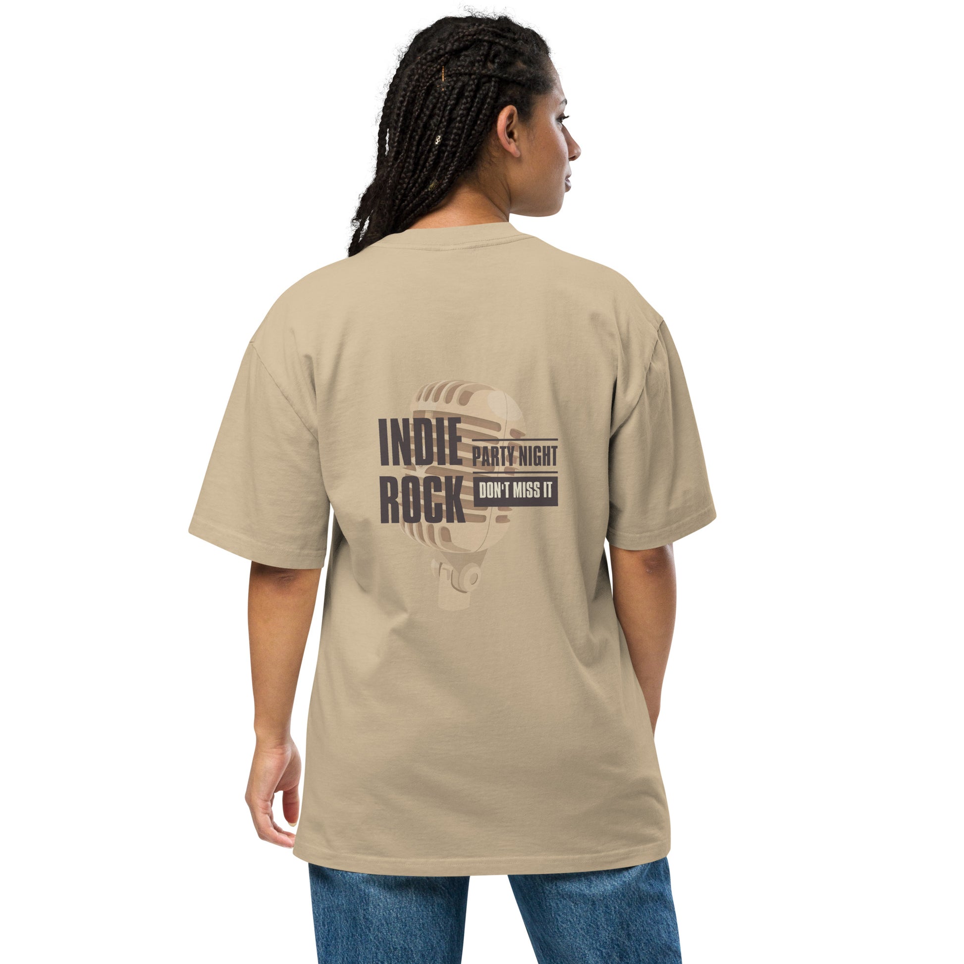 Woman viewed from the back wearing a faded khaki oversized tee with 'INDIE ROCK' text and microphone graphic, promoting 'Party Night – Don’t Miss It', paired with denim jeans, conveying a relaxed music event vibe.