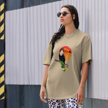 Woman in a faded khaki oversized tee with colorful toucan graphic design, symbolizing vibrant self-expression.