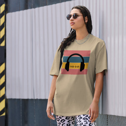 Cool woman wearing a faded khaki graphic t-shirt with a retro headphone and soundwave design.