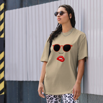 Woman wearing a Women's Quirky Retro Red Specs faded khaki Oversized Graphic Tee, embodying cool self-expression with a touch of retro charm.