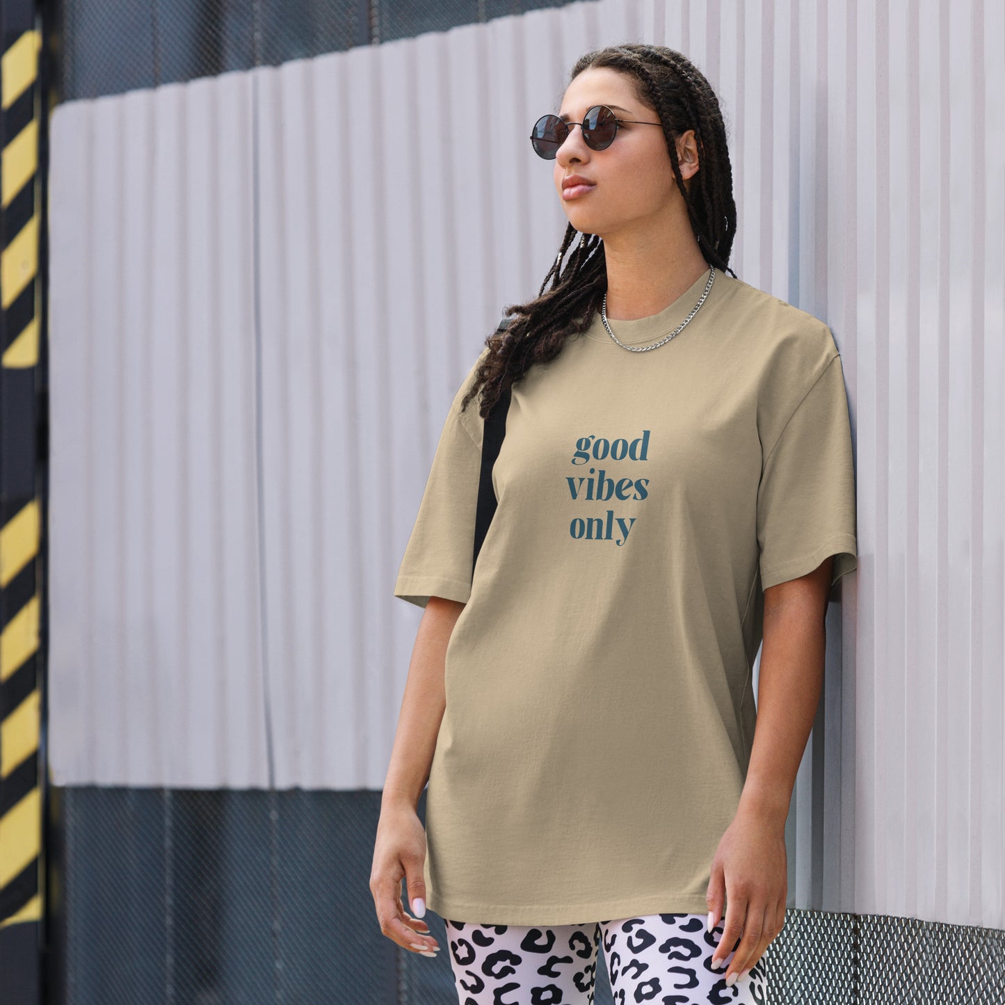 Woman making a statement in Be You Out Loud's Good Vibes Only khaki bone Oversized Tee, reflecting a cheerful and optimistic outlook with a simple yet powerful message.