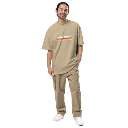 Smiling man sporting the d Men's "Retro Awesome" Oversized Tee in faded khaki with vibrant retro graphics, embodying timeless cool and self-expression.