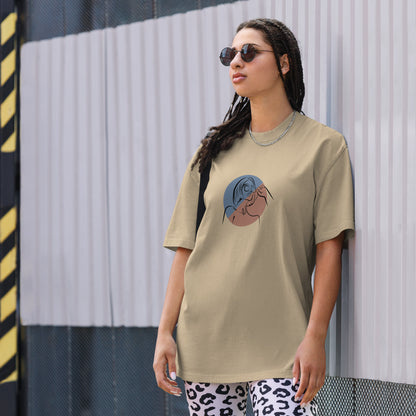 Woman wearing a faded khaki oversized faded tee with an elegant lady line art design, highlighting unique self-expression and artistic fashion.