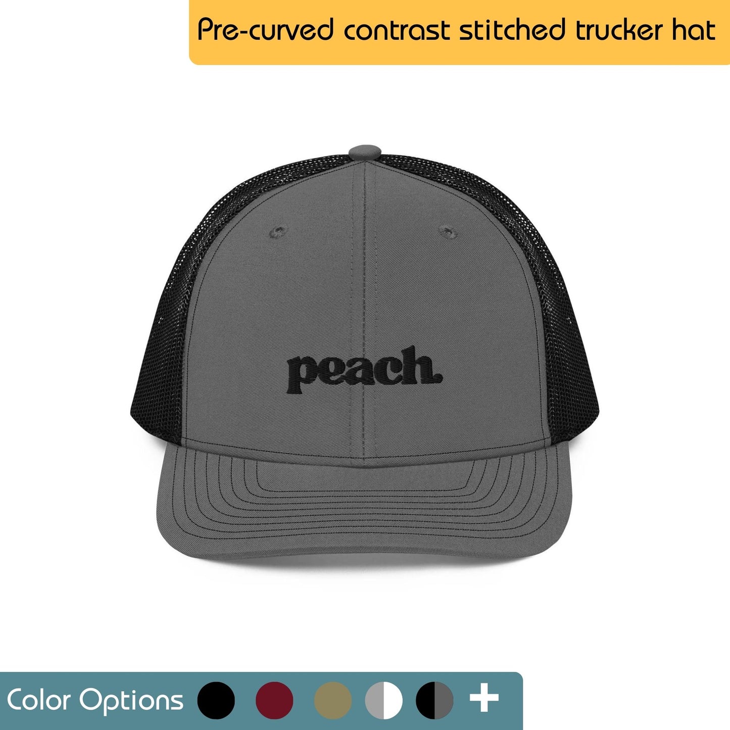 White trucker hat with the word "GRATITUDE" embroidered in black across the front. Text "Trucker Hat" is written above the image, and "Color Options+" is written below the image.