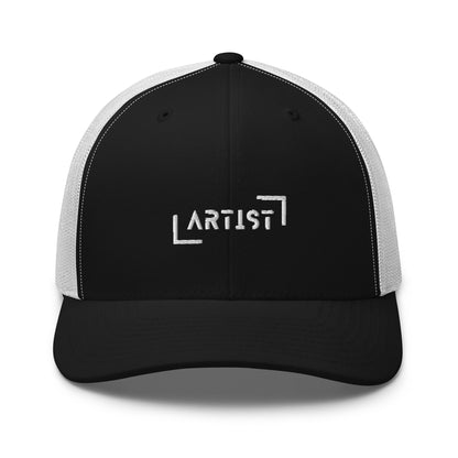 Black and white trucker cap with white "ARTIST" embroidery on the front, featuring a mesh back and an adjustable strap for a personalized fit.