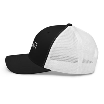 Black and white trucker cap with a mesh back, featuring a side view with the word "LIFE" embroidered in black on the side panel.