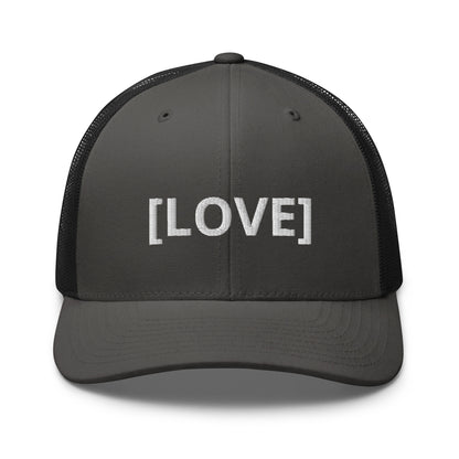 Grey and black trucker cap with the word 'LOVE' embroidered in white within brackets, symbolizing an inclusive message, featuring a mesh back and available in multiple colors.