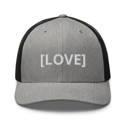 Grey and Black trucker cap with the word 'LOVE' embroidered in white within brackets, symbolizing an inclusive message, featuring a mesh back and available in multiple colors.