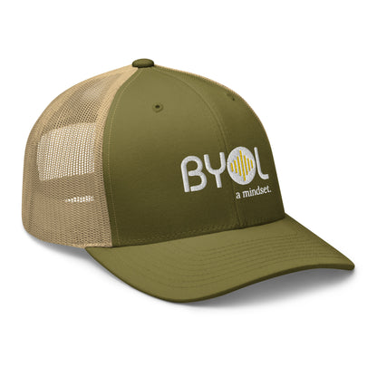 Military green and khaki retro trucker hat with "BYOL a mindset" embroidered on the front in white and yellow, displayed against a clean background. Available in various colors: black, white, brown, green, and beige.