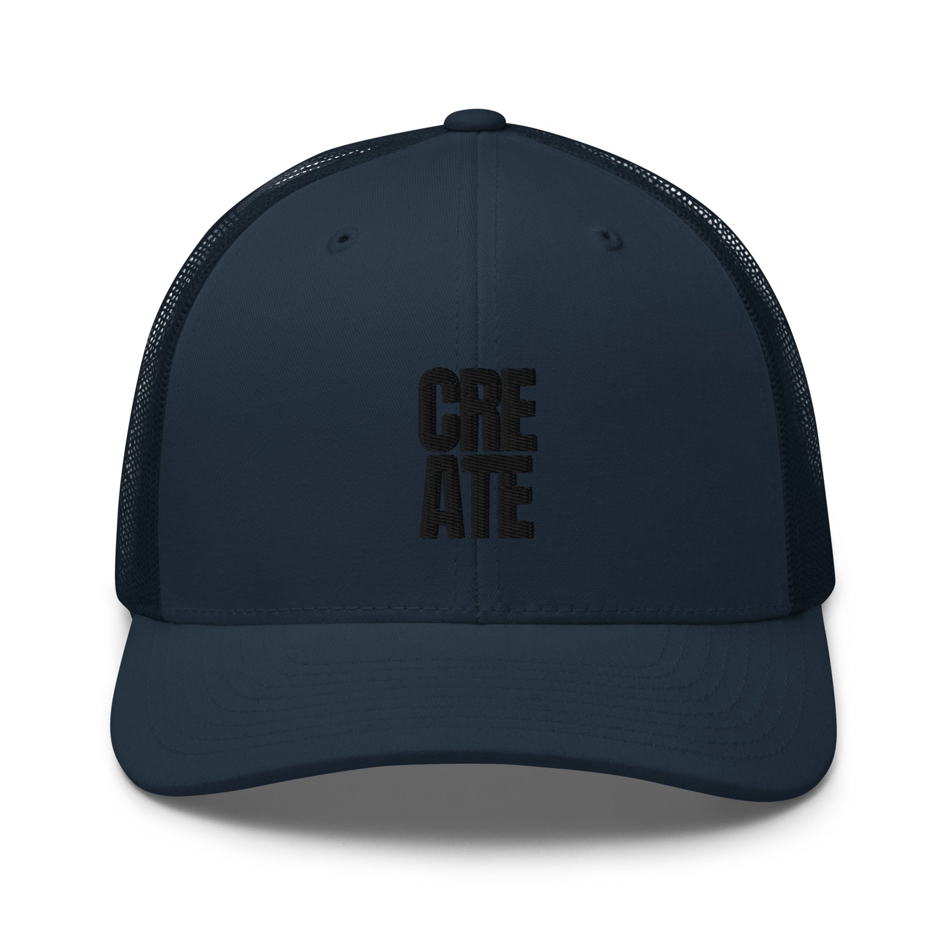 Navy blue trucker cap with "CREATE" embroidered in black on the front, featuring a mesh back and adjustable strap.